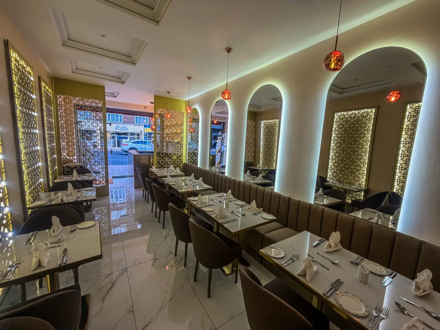 Restaurant dining room in Streatham with LED backlit arched mirrors and copper pendant lights
